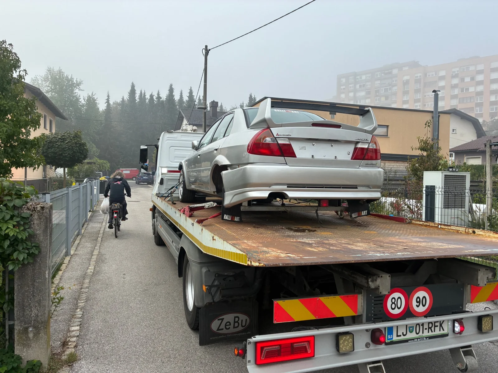 Mitsubishi Lancer Evolution IV on a recovery truck before the revival project begins